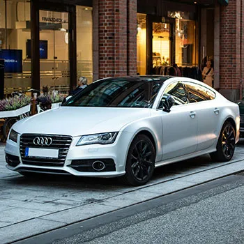 White Audi car parked on urban street