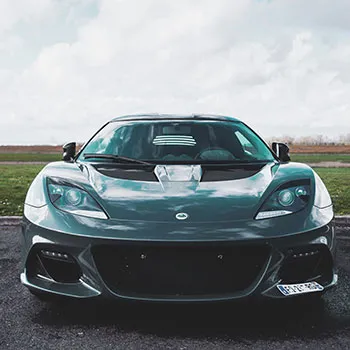 Sleek gray sports car on open road.